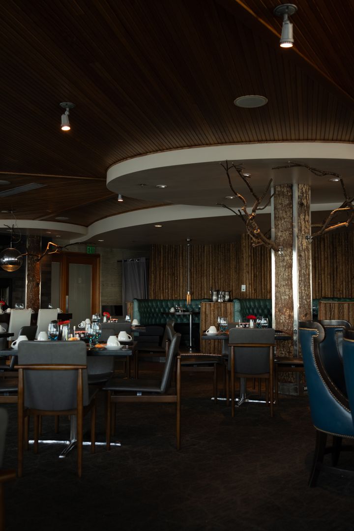 A real restaurant interior with a wood ceiling and dining seating.